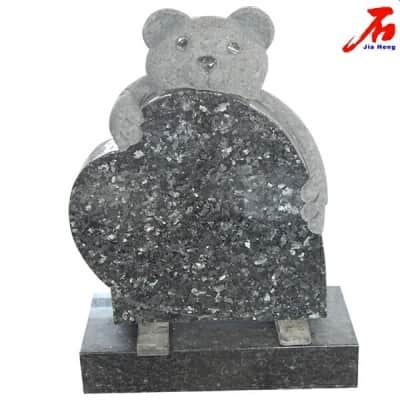 small shaped black granite tombstone with hand carved bear