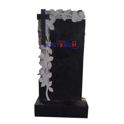 Black granite headstone with flower and cross carving