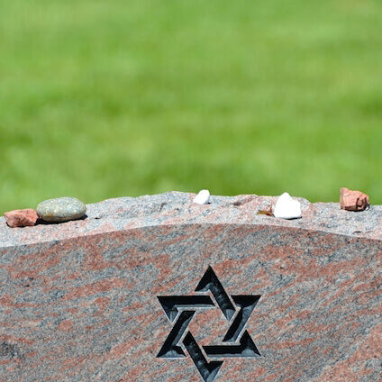 What do pebbles on a gravestone mean