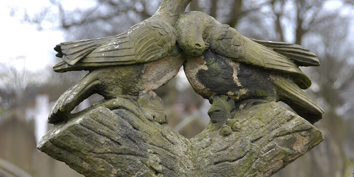 carved birds on headstone