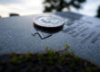 What does a quarter left on a grave mean